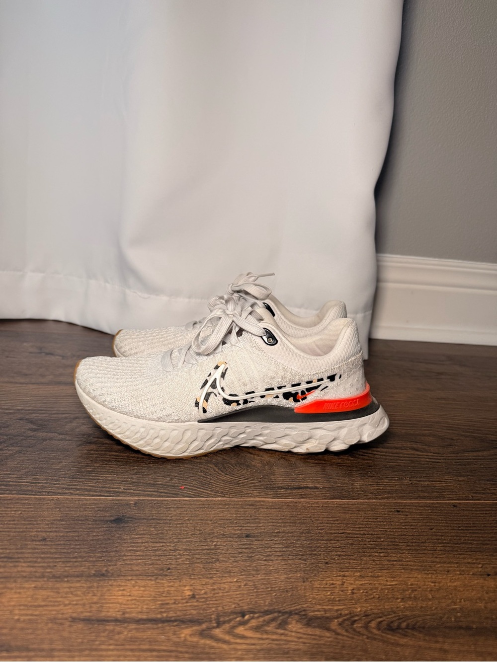 **NWOT** Nike White Flyknit Running Shoes with Black and Orange Accents - Picture 2 of 5